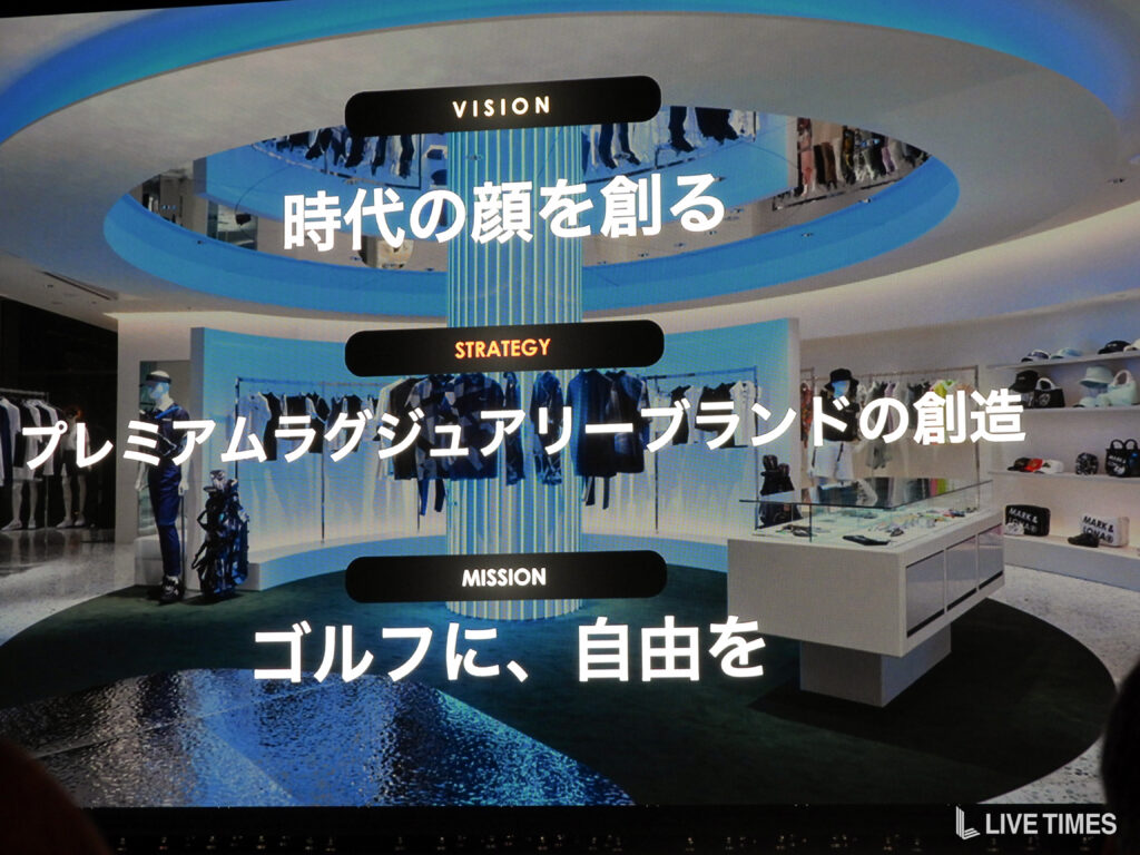 Retail store display with a large blue circular centerpiece and signs reading VISION, STRATEGY, MISSION over Japanese text.