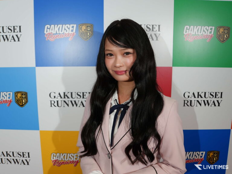Young woman with long black hair posing in front of a colorful backdrop featuring GAKUSEI RUNWAY logos.